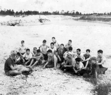 Boys sitting at an undeveloped site