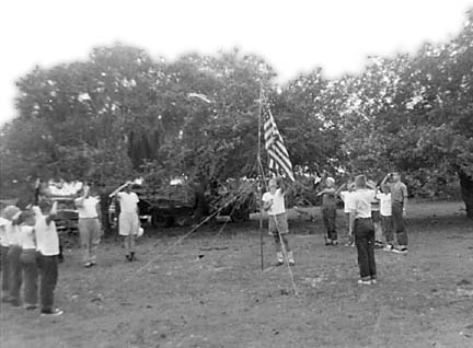 Saluting flag as it is raised