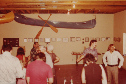 Inside Scout House at dedication. Floyd Self and Doug Turner facing forward